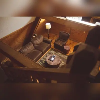 an overhead view of a living room with a couch and a chair at A-Frame #03 - by The Chalets in Logan
