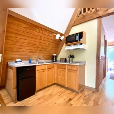 a kitchen with a sink and a microwave at A-Frame #05 - by The Chalets in Logan