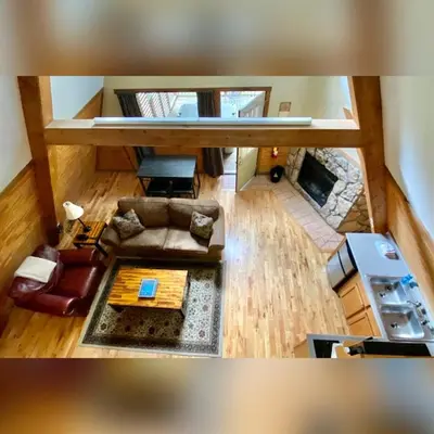 an overhead view of a living room with a fireplace at A-Frame #08 - by The Chalets in Logan
