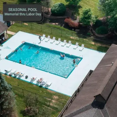 an overhead view of a swimming pool with people in it at A-Frame #12 - by The Chalets in Logan