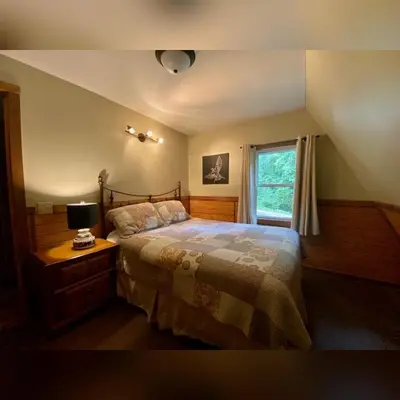 a bedroom with a bed and a window at A-Frame #14 - by The Chalets in Logan