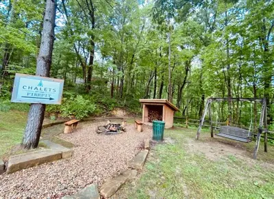 a park with a playground and a swing and a sign at A-Frame #17 - by The Chalets in Logan