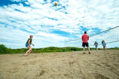 a group of people playing a game of volleyball at Hocking Hills Deluxe Safari Glamping Tents in Logan