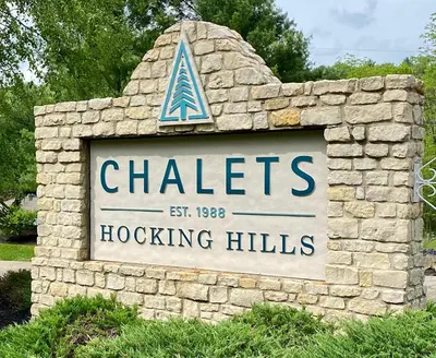 a sign for chateslocking hills in a stone wall at Hidden Heights - by The Chalets in South Bloomingville
