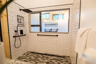 a bathroom with a shower with a mirror at Legends Lane A - by The Chalets in Logan