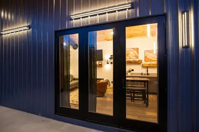 a room with sliding glass doors and a dining room at Legends Lane C - by The Chalets in Logan