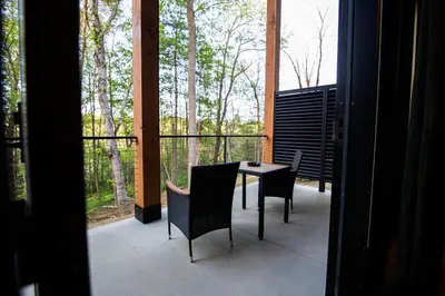 a patio with a table and chairs on a balcony at Legends Lane E - by The Chalets in Logan