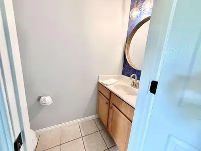 a bathroom with a sink and a mirror at 2 BR 1 & half Bath Retreat, Sleeps 7, only 3 Miles to Ark! in Williamstown