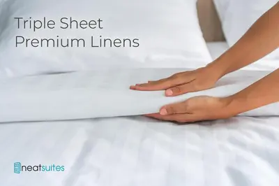 a woman lying on a bed holding a white sheet at 3BR Condo for 7 - Only 3 Miles to Ark Encounter! in Williamstown
