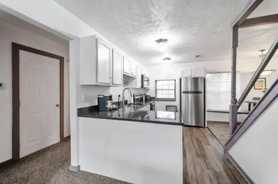 a kitchen with white cabinets and a counter top at Bamboo Retreat- Private Parking -New Reno -Central in Columbus