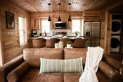 a living room with a couch and a kitchen at Middlefork Ridge Entire Property in Laurelville