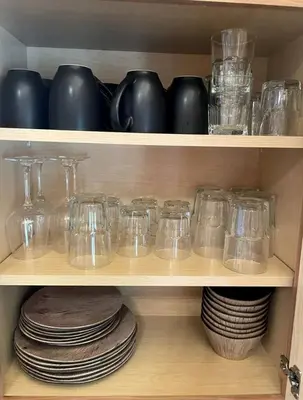 a wooden shelf with glasses and plates on it at Modern Spacious Cabin near Tappan Lake with Jacuzzi and Panoramic Views in Ohio in Deersville