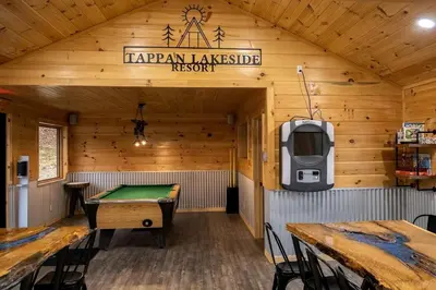 a room with a ping pong table and a tv at Luminous Cabin near Tappan Lake with Hot-Tub, BBQ and Deck in Ohio in Deersville