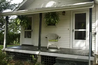 a porch of a house with a chair on it at Tranquil Weekend Getaway for a Large Group near the Cuyahoga Valley National Park, Ohio in Sandusky