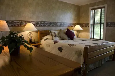 a bedroom with a bed and two lamps and a table at Secluded 1800's Farmhouse Rental Minutes from Cedar Point, Ohio in Sandusky