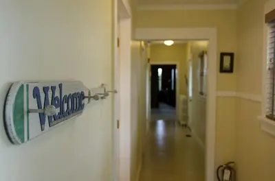 a sign is hanging on a wall in a hallway at Secluded 1800's Farmhouse Rental Minutes from Cedar Point, Ohio in Sandusky