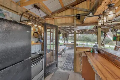 a kitchen with wooden walls and a counter in a house at RV Camper in New Lexington