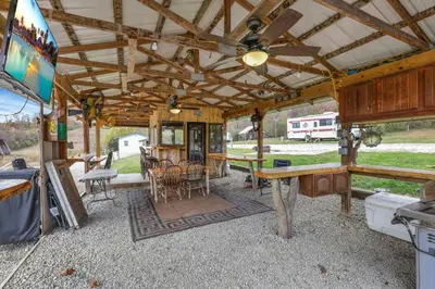 an outside view of a house with a table and chairs at RV Camper in New Lexington