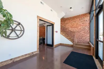 an open hallway with a brick wall and a staircase at Courtyard Queen - Room 2 in Versailles
