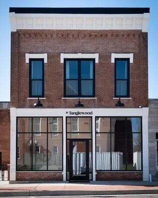 a brick building with glass doors on a street at Courtyard King - Room 3 in Versailles