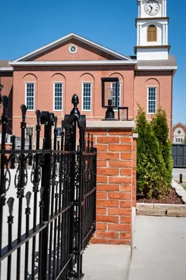 a black fence in front of a building with a clock tower at Courtyard King - Room 4 in Versailles