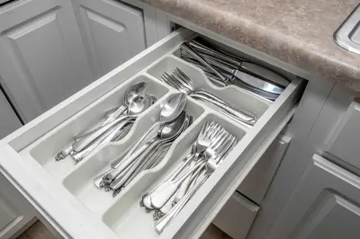 a white drawer with silver utensils in a kitchen at The Grand Elm Suites in Ludlow