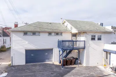a white house with a garage and a house at The Grand Elm Suite 2 in Ludlow