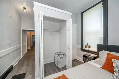 a bedroom with a large mirror next to a bed at Chic Modern Gem with Style Suites in Cincinnati