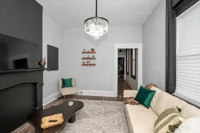 a living room with a couch and a chandelier at Chic Modern Gem with Style Suites in Cincinnati