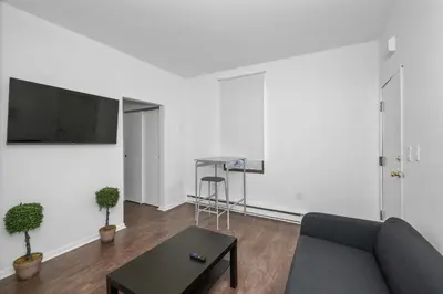 a living room with a couch and a table at Northside Suites - 4 Apartments in Cincinnati