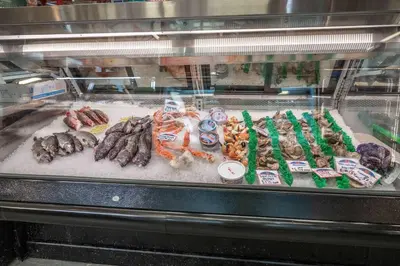 a display case with different types of meats and vegetables at Findlay Market Suites - 6 in 1 in Cincinnati