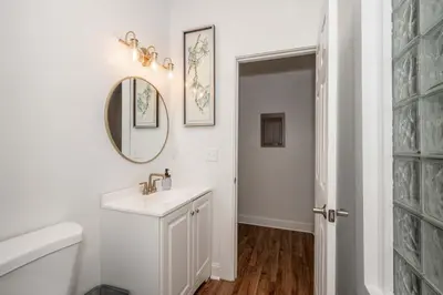 a white bathroom with a sink and a mirror at The Heart of Madison 3 in Covington