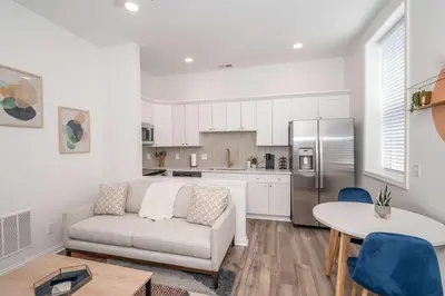 a living room with a couch and a kitchen at New Listing - Covington Charm Suites in Covington