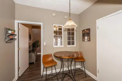 a dining room with a table and two stools at Monmouth Loft 3 - Heart of Newport in Newport
