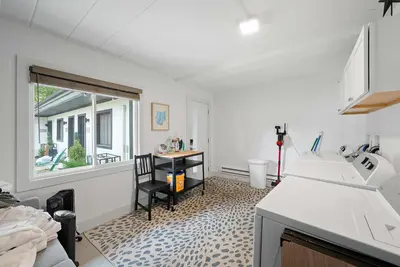 a kitchen with a sink and a table and a window at Chic City Retreat 93A in Columbus
