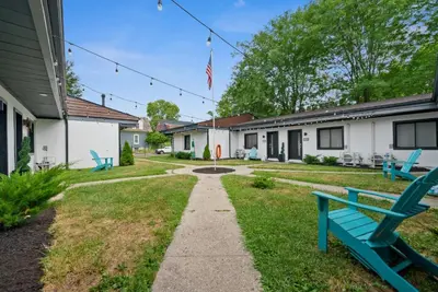 a yard with blue benches and an american flag at Chic City Retreat 93J For 2 in Columbus
