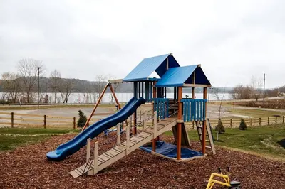 a playground with a slide in a park at Secluded A-Frame Incredible for Water Activities by Tappan Lake in Ohio in Deersville