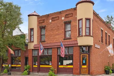 a brick building with american flags in front of it at CGV - Unique and Memorable 3BDR Stay in Columbus