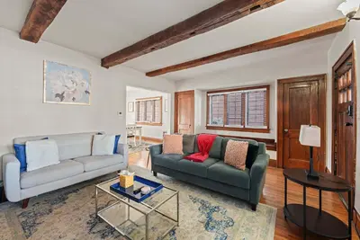 a living room with a couch and a table at Tibet Twins 1 Cozy Stay for 6 in Columbus