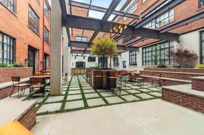 a courtyard with tables and chairs in a building at 1 BD Apt l Downtown l Parking l Fast Wi-Fi l Café in Cleveland