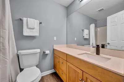 a bathroom with a toilet and a sink and a mirror at Downtown Cleveland Loft Near CSU, Playhouse, Arena in Cleveland