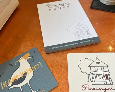 a table with three cards and a book at Fiesinger House - Entire Historic Home, Downtown Sandusky in Sandusky