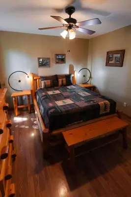 a bedroom with a bed and a ceiling fan at Cheerful Two Bdrm Cabin with Hot Tub & Pet Friendly in Rockbridge
