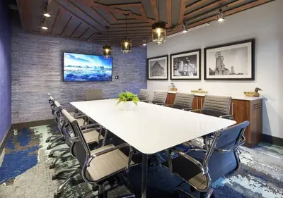 a conference room with a large white table and chairs at 2 New Studios with Stunning City Views in Cleveland