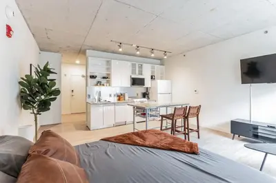 a living room with a couch and a table at 2 New Studios with Stunning City Views in Cleveland