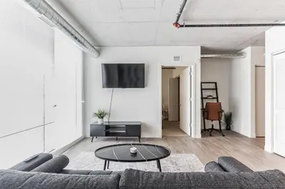 a living room with a couch and a table at 2 Centrally Located DT Luxury studios at City Club in Cleveland