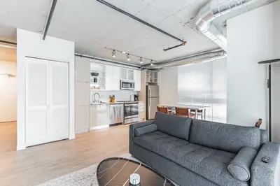 a living room with a couch and a table at 2 Centrally Located DT Luxury studios at City Club in Cleveland