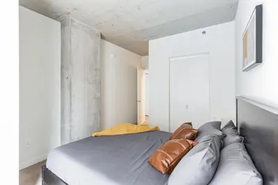 a bedroom with a bed with a leather couch at Skyline 776 - Combined 1-BR & Studio in Cleveland
