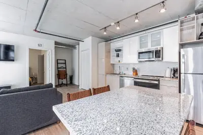 a kitchen and living room with a table and a couch at Skyline 776 - Combined 1-BR & Studio in Cleveland