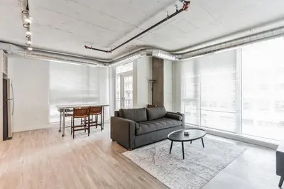 a living room with a couch and a table at Skyline 776 - 2BR 1BR & Studio Units with Parking in Cleveland